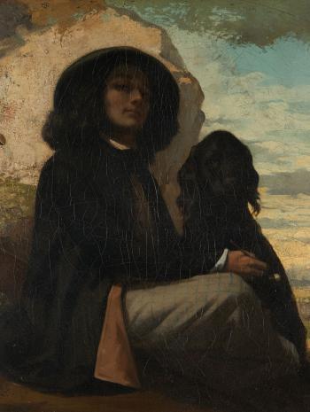 un homme avec un chapeau avec un chien noir